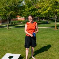 Woman in red top playing cornhole